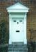 Door Frontage. Panelled and fluted with dog toothed canopy
