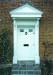 Door Frontage. Panelled and fluted with dog toothed canopy